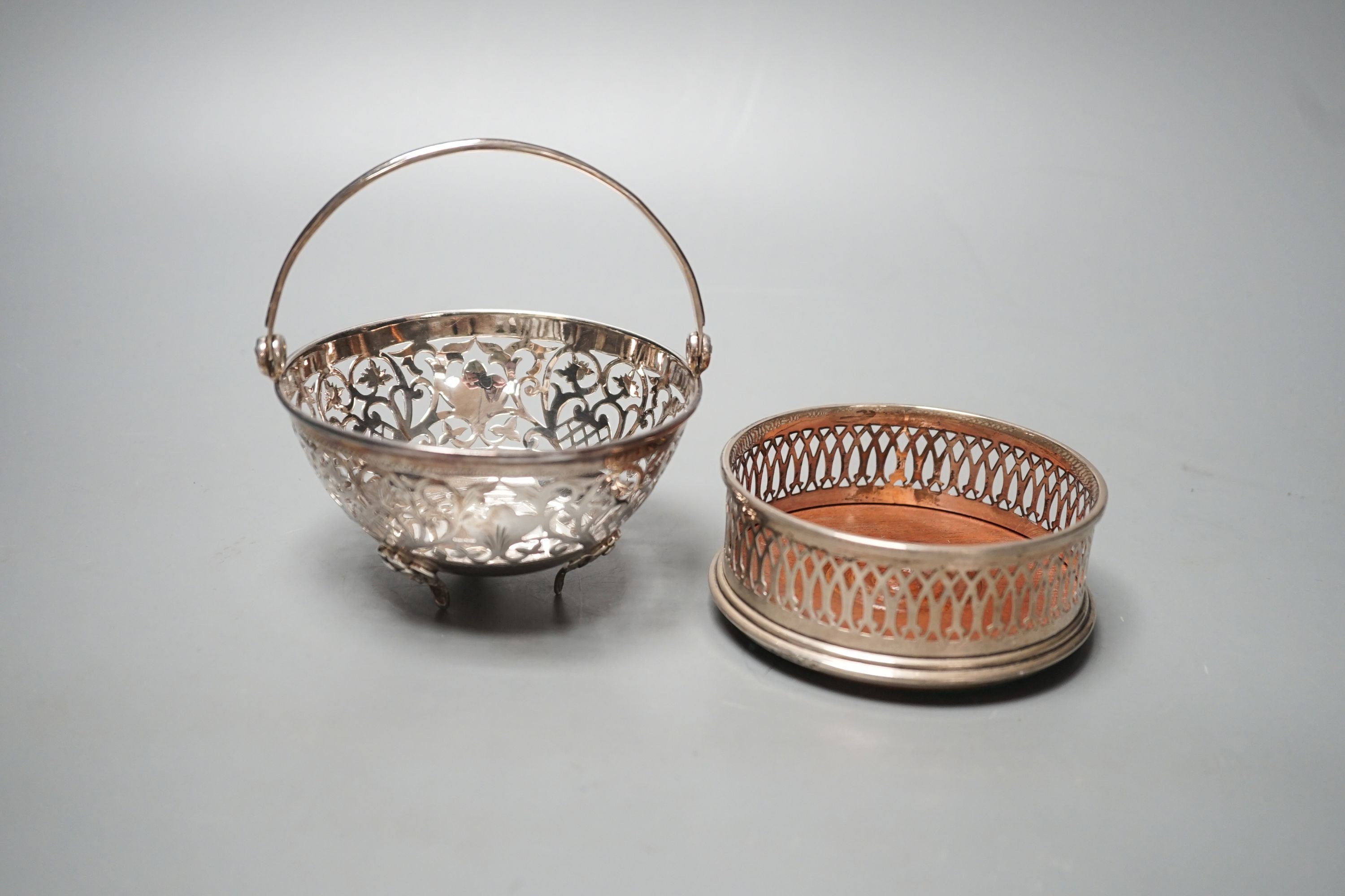 A modern pierced silver sweetmeat basket, 10cm and a similar pierced silver wine coaster.